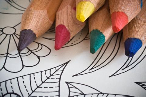 Coloring page and sharpened colored pencils.