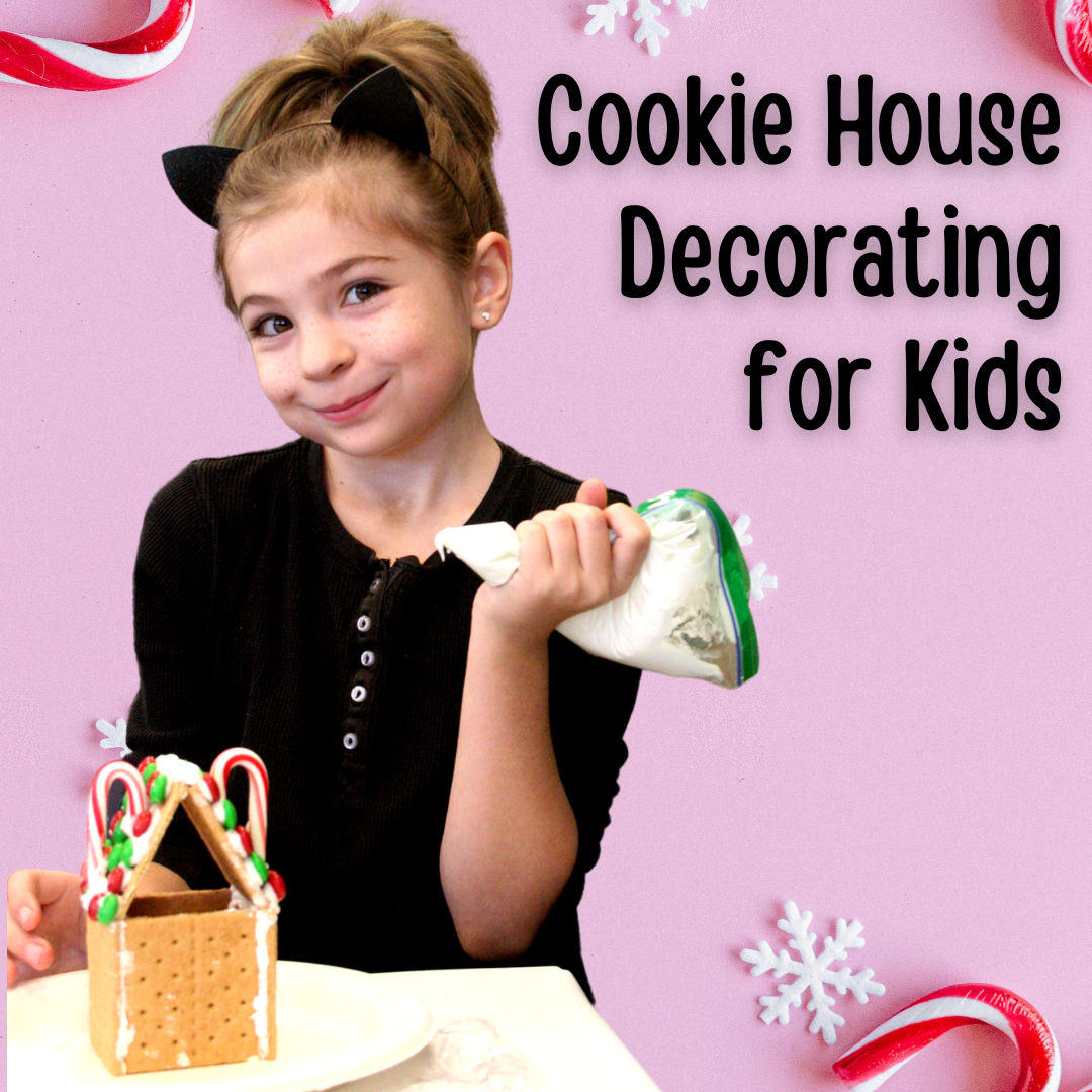 Girl with icing bag and graham cracker house